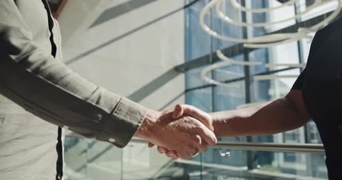 Business Handshake in Modern Lobby of Office Building