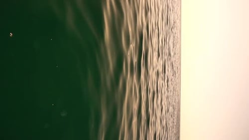 Vertical Aerial View on Sea Water Surface Camera Flies Over Clear Sea Water Sun Glare Abstract