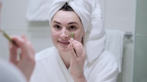 Woman Uses Jade Roller for Skincare Routine