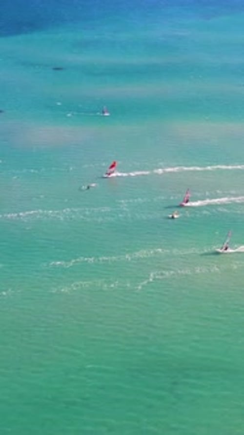 Windsurfers Sailing on Turquoise Waters, Aerial View