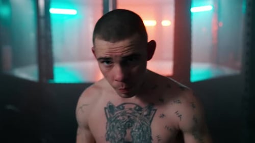 Shirtless Man with Tattoos in a Gym