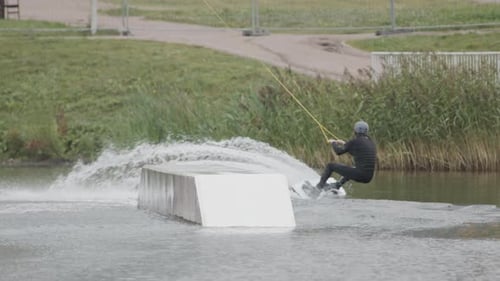 Adult Surfer Riding on Wakeboard in Cable Park