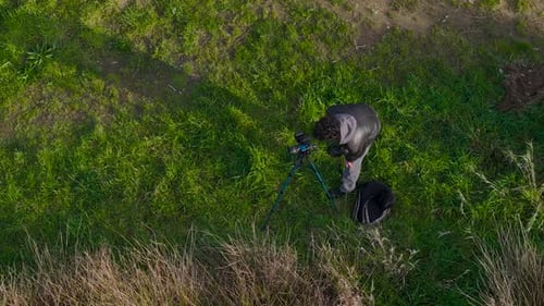 Nature Photographer Finding View For Shooting With Camera On Tripod. drone rotating shot
