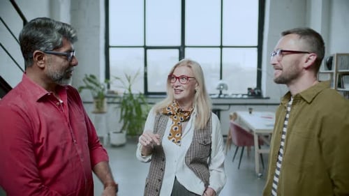 Team of Diverse Colleagues Having Conversation in Modern Office