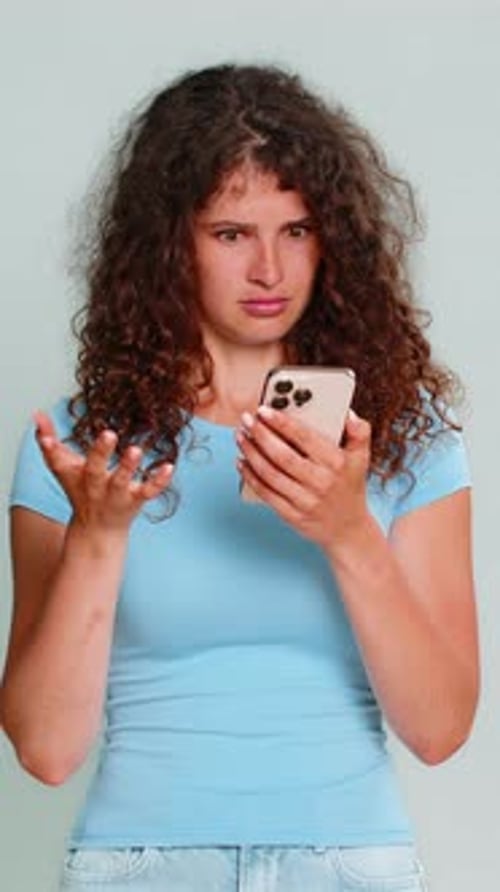 Young Woman Reacts to Phone News with Surprise