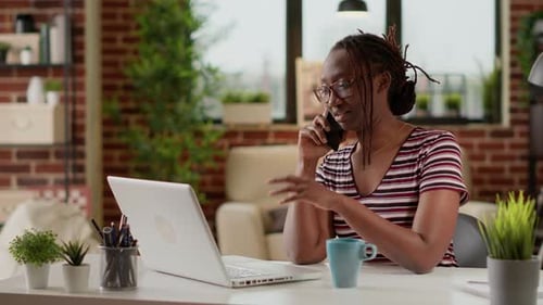 Woman Works from Home and Talks on Phone