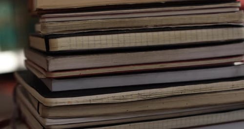 Stack of Bound Notebooks in Indoor Setting