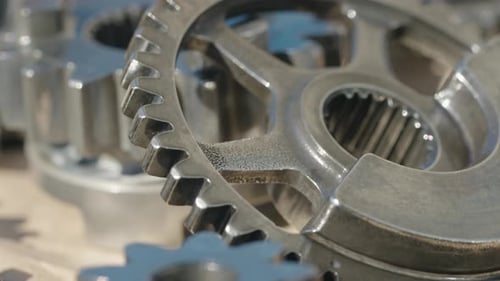 Shiny Metallic Gears Rotating in Close Up
