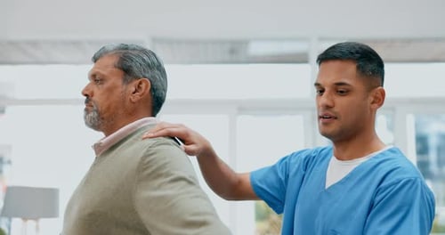 Patient Receiving Assistance with Arm Exercise in Clinic