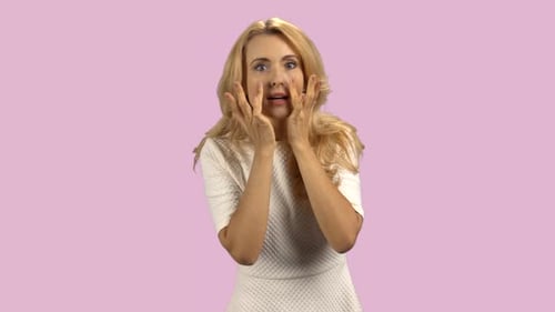 Woman Styling Her Blond Hair in Studio
