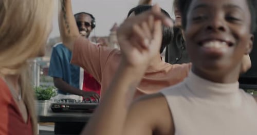 Diverse Friends Dancing at a Rooftop Party