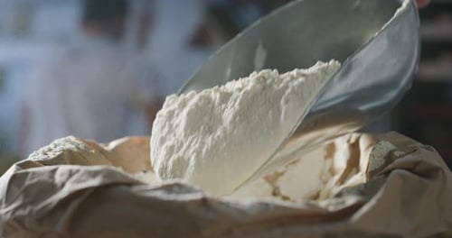 Flour Being Scooped and Poured into Bag