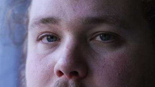Young man close up eyes looking at camera. One caucasian casual person