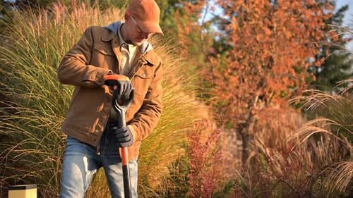 Man Gardening in Autumn Rural Landscape