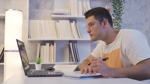 Young Adult Working and Studying at Home