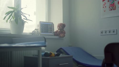 Modern pediatrician office interior with health check equipment and soft toy bear