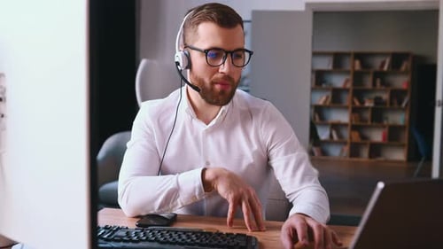 Man Talking with Headset Working from Home Office
