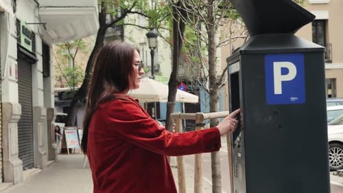 Woman Driver Pays to Park Cars at a Parking Garage By Credit Card