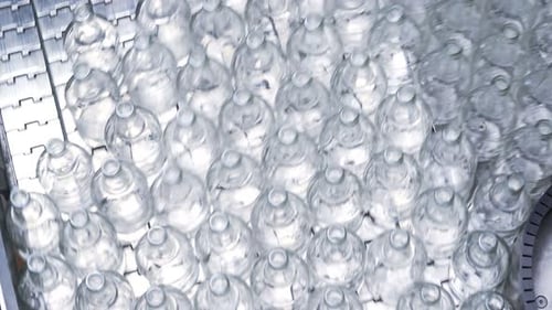 Lot Of Bottles Are Conveyed By Auto Transporter. Automatic Mill For Making Packing Materials And ...