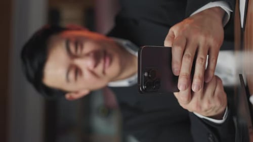 Entrepreneur Texting Message on Modern Smartphone Indoors