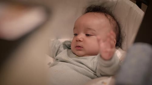 Adorable Baby Lying in Baby Rocker