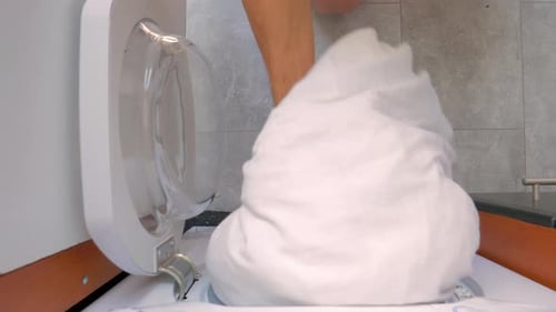 Hand Put White Sheets Inside Washing and Close Door, Directly Above