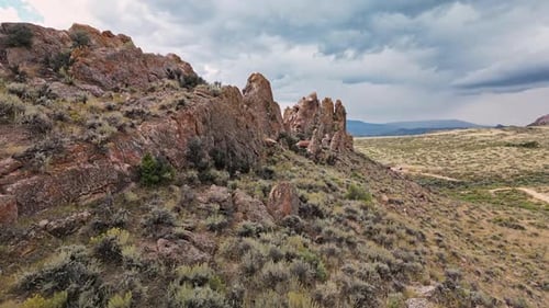 Flying up and through rocky cliff formation along the shore of Flaming Gorge