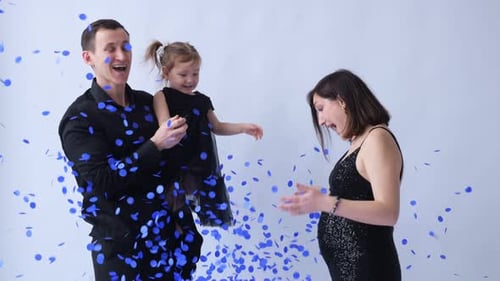 Family Celebrating Future Baby Boy with Blue Confetti