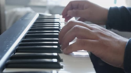 Close Up of Hands Playing a Keyboard
