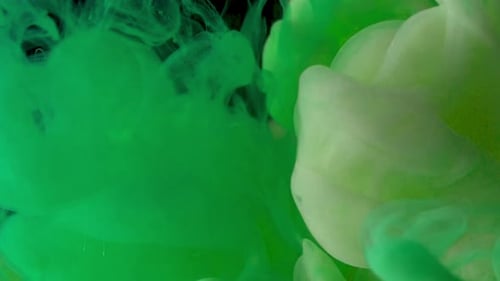Green and white ink swirling together