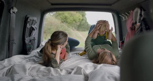 Lesbian Couple with Child in Campervan on Holiday