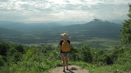 Excited Happy Tourist Woman Jumping Joyfully on the Top of Mountain