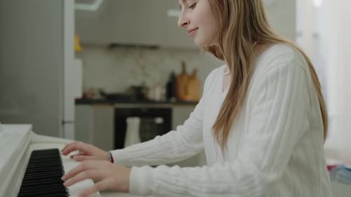 Young Woman Playing Piano at Home