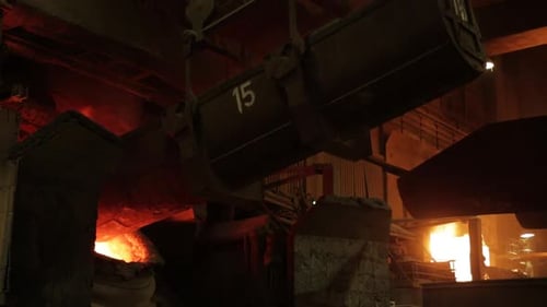 Intense molten metal pouring in a dark industrial foundry, number 15 on equipment, glowing ambiance