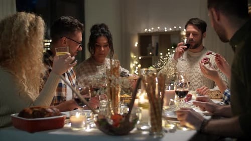 Friends Enjoying Dinner Party with Wine and Laughter