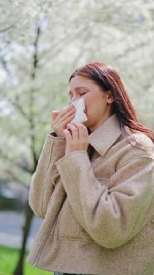 Woman Suffering From Spring Allergies Outdoors