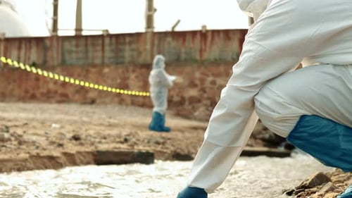 Scientists Collect Water Sample near Industrial Area
