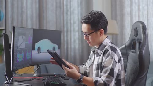 Man Works on Car Design with Tablet