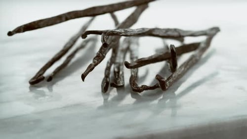 Vanilla Beans Falling Onto Marble Surface in . on Phantom
