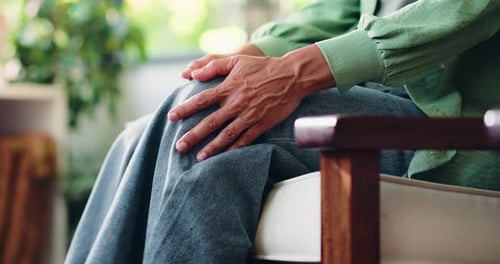 Senior Woman Resting Hands on Knee Indoors