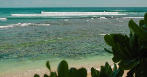 Turquoise ocean waves roll on white sandy beach, blue crystal clear water. Peaceful zen nature backg