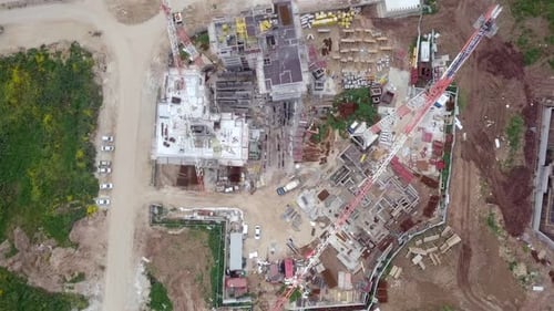 Construction site with moving Cranes, Aerial view