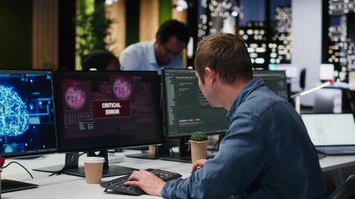 Upset Programmer at Office Desk Thinking How to Fix Critical Error Alert