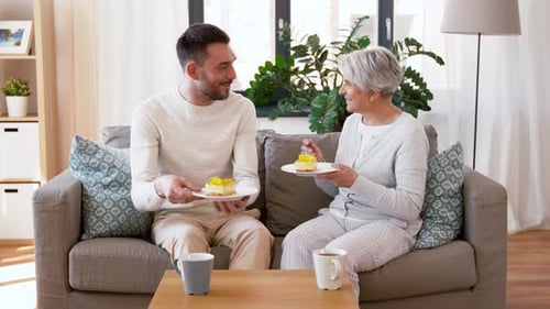 Man and woman eat cake at home together