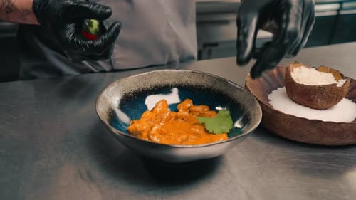 restaurant chef serves freshly prepared delicious curry in a plate professional Asian cuisine