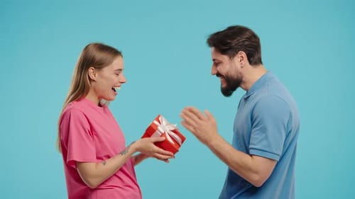 Woman Gives Birthday Gift to Happy Man