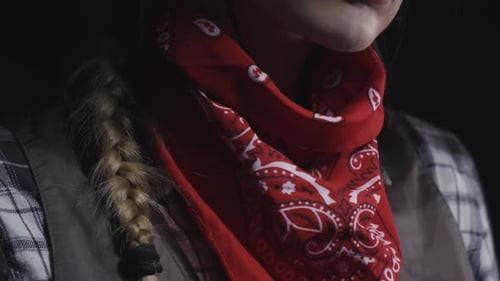 Close up of a young cowgirl putting her red mask on, 4k