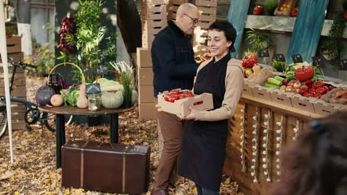 Woman Holds Tomatoes at Outdoor Farmers Market