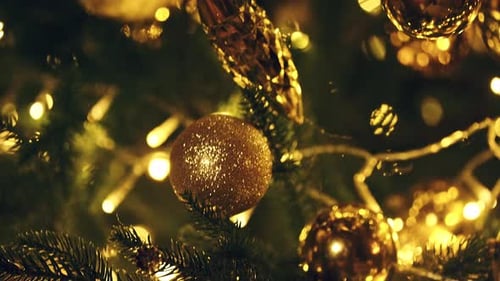 Christmas Tree Decorated with Golden Ornaments and Lights