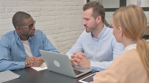 Confident Mixed Race Business People Talking in Office